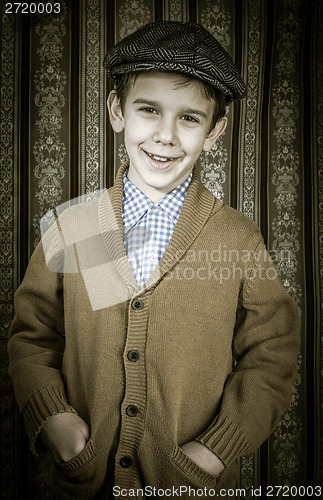 Image of Smiling child in vintage clothes and hat