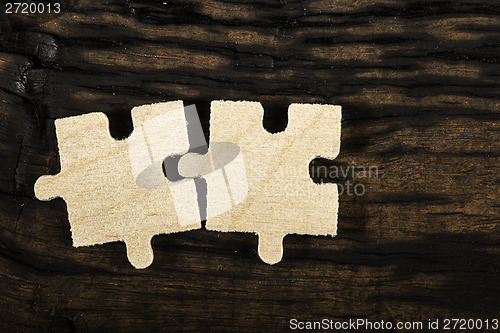 Image of Wooden puzzle on dark background. 