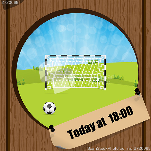 Image of Soccer ball and gate in wooden fence hole