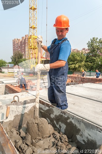 Image of Worker kneads solution for bricklayers