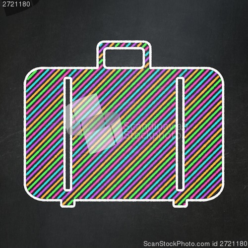 Image of Vacation concept: Bag on chalkboard background