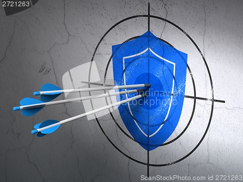 Image of Protection concept: arrows in Shield target on wall background