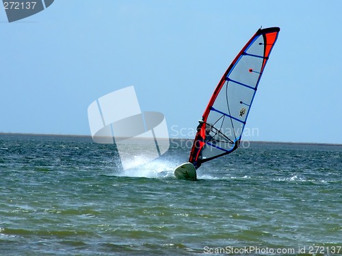 Image of windsurfer on waves of a gulf in the afternoon