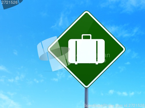 Image of Vacation concept: Bag on road sign background
