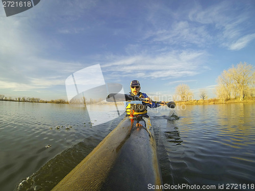 Image of racing kayak against sunset