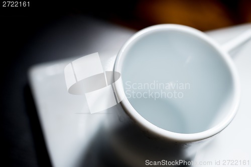 Image of White cup on dark table