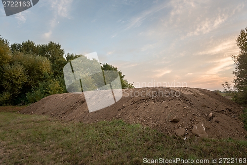 Image of Large pile of soil under blue sky