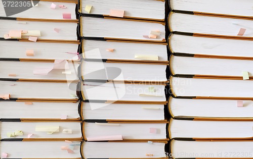 Image of stack of books with sticky notes