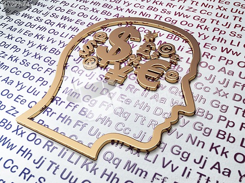 Image of Education concept: Golden Head With Finance Symbol on Alphabet background