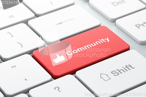 Image of Social network concept: Thumb Up and Community on computer keyboard background