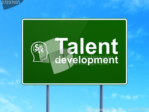 Image of Education concept: Talent Development and Head With Finance Symbol on road sign background