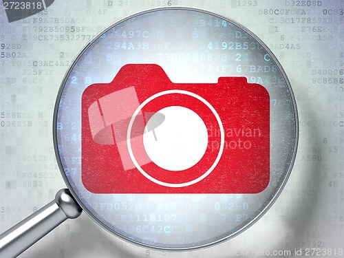 Image of Vacation concept: Photo Camera with optical glass on digital background