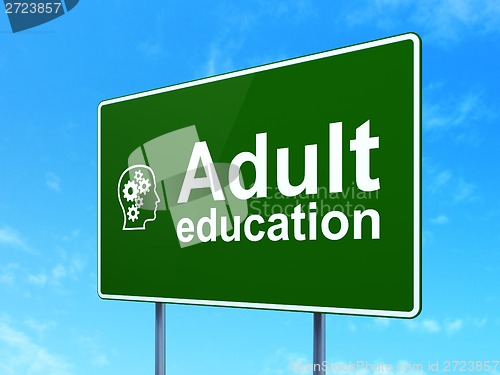 Image of Education concept: Adult Education and Head With Gears on road sign background