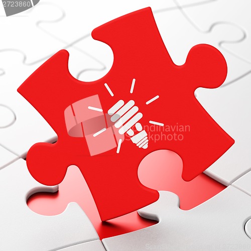 Image of Business concept: Energy Saving Lamp on puzzle background