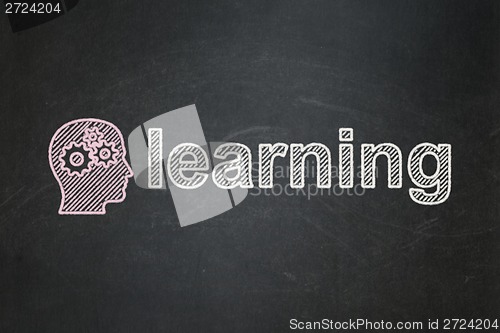 Image of Education concept: Head With Gears and Learning on chalkboard background