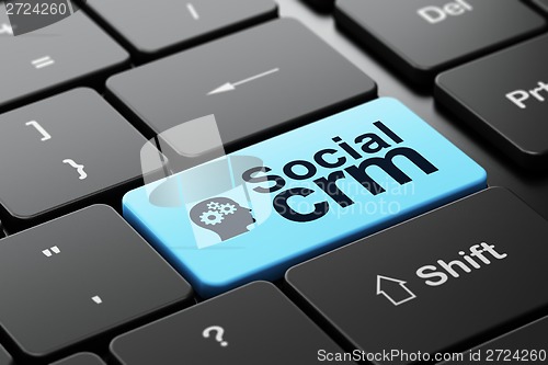 Image of Finance concept: Head With Gears and Social CRM on keyboard