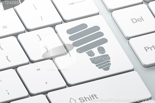 Image of Finance concept: Energy Saving Lamp on computer keyboard background