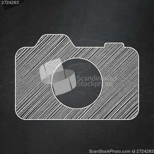 Image of Travel concept: Photo Camera on chalkboard background