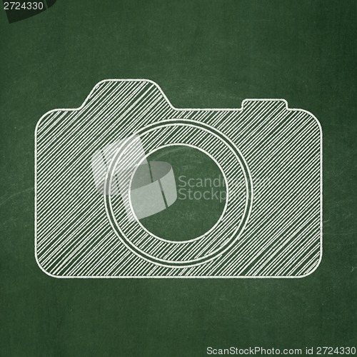 Image of Travel concept: Photo Camera on chalkboard background