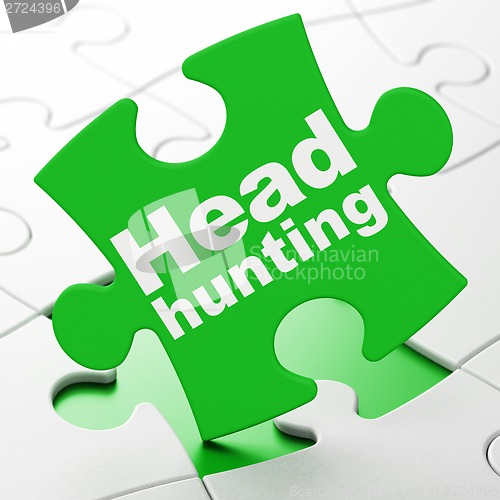 Image of Finance concept: Head Hunting on puzzle background