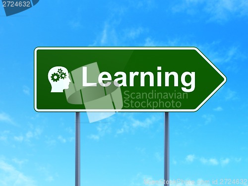 Image of Education concept: Learning and Head With Gears on road sign background