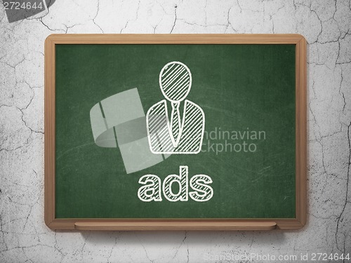 Image of Advertising concept: Business Man and Ads on chalkboard background