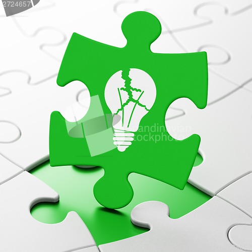 Image of Business concept: Light Bulb on puzzle background