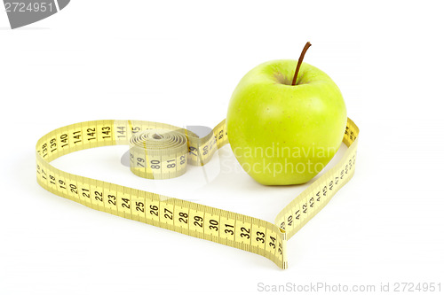 Image of green apple with a measuring tape and heart symbol isolated