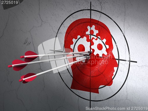 Image of Business concept: arrows in Head With Gears target on wall