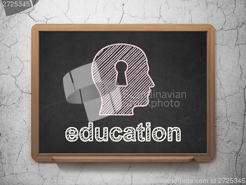 Image of Education concept: Head With Keyhole and Education on chalkboard background