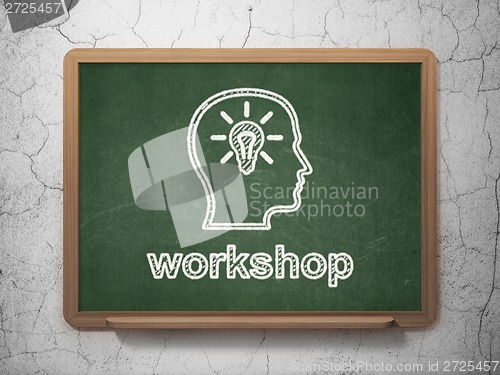 Image of Education concept: Head With Lightbulb and Workshop on chalkboard background