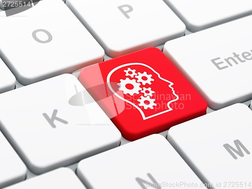 Image of Advertising concept: Head With Gears on computer keyboard background