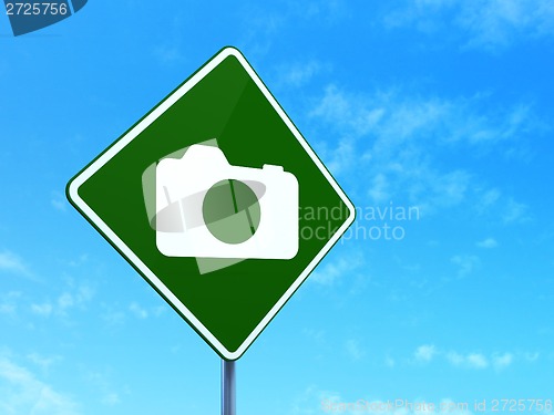 Image of Vacation concept: Photo Camera on road sign background