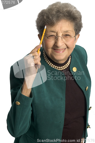 Image of healthy senior woman pointing to head
