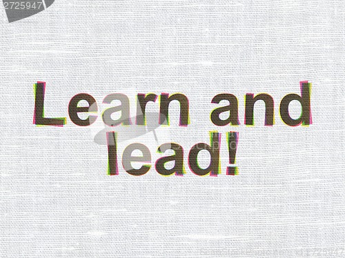 Image of Education concept: Learn and Lead! on fabric texture background