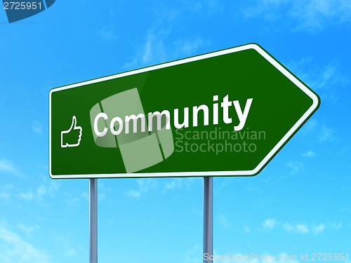 Image of Social network concept: Community and Thumb Up on road sign
