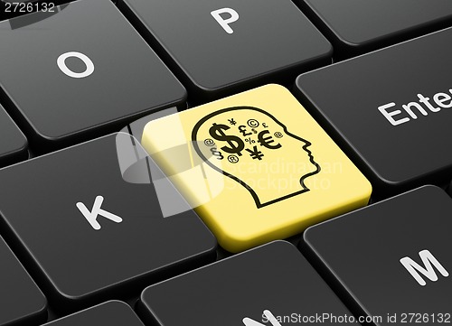 Image of Advertising concept: Head With Finance Symbol on computer keyboard background