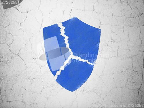 Image of Protection concept: Broken Shield on wall background