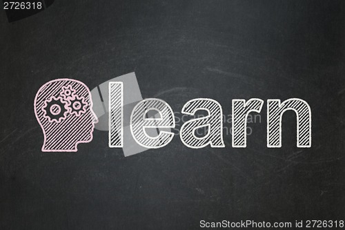 Image of Education concept: Head With Gears and Learn on chalkboard background