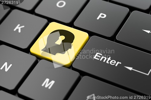 Image of Finance concept: Head With Keyhole on computer keyboard background