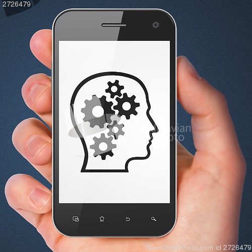 Image of Finance concept: Head With Gears on smartphone