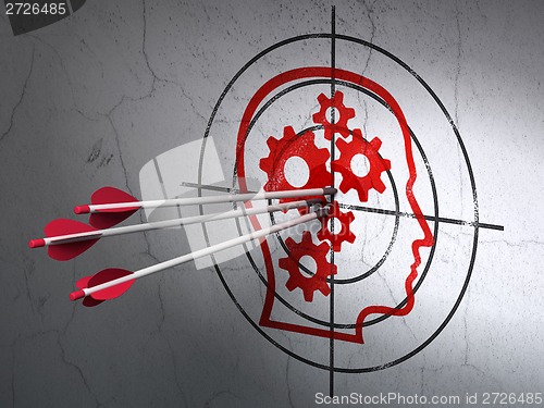 Image of Advertising concept: arrows in Head With Gears target on wall background