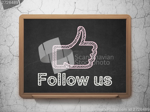 Image of Social media concept: Thumb Up and Follow us on chalkboard background