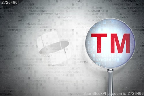 Image of Law concept:  Trademark with optical glass on digital background
