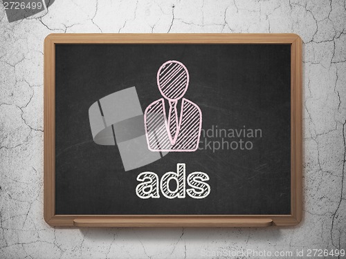 Image of Advertising concept: Business Man and Ads on chalkboard background