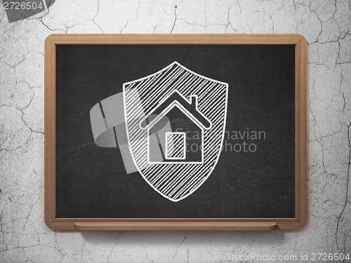 Image of Finance concept: Shield on chalkboard background