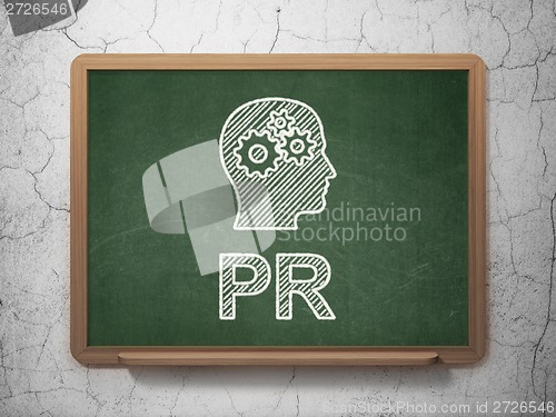 Image of Marketing concept: Head With Gears and PR on chalkboard background