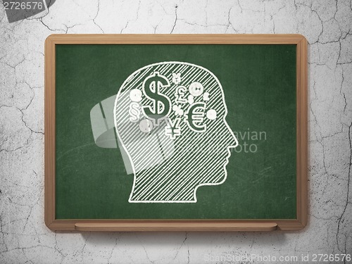 Image of Education concept: Head With Finance Symbol on chalkboard background