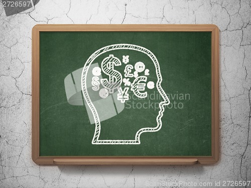 Image of Marketing concept: Head With Finance Symbol on chalkboard background