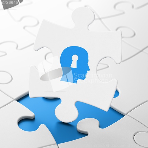 Image of Marketing concept: Head With Keyhole on puzzle background